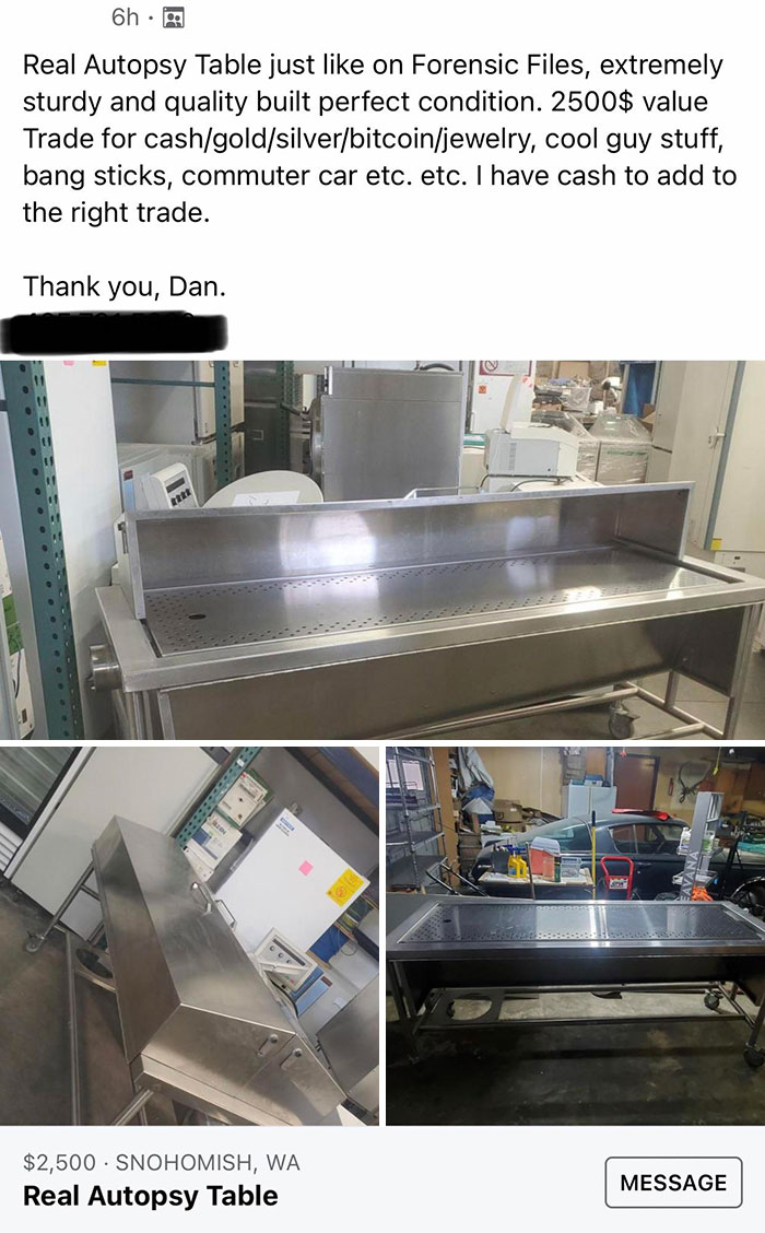 Autopsy table for sale online, featuring stainless steel construction, in a storage setting.