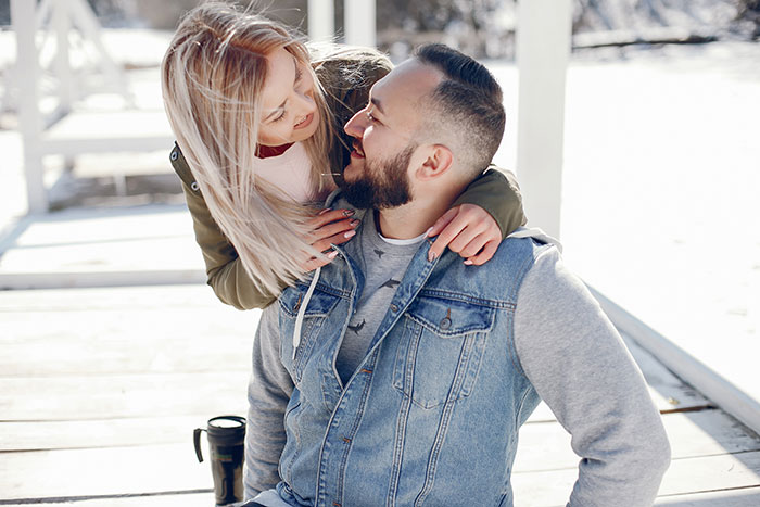 Couple sharing a loving moment on a winter day, highlighting adorable partner gestures.