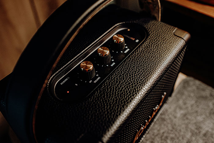 Close-up of a black vintage speaker with gold knobs, representing adorable things that make partners feel like "my person."