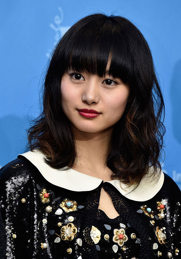 Deadpool cast member Shioli Kutsuna with a floral outfit, featuring a white collar and black sequined design.