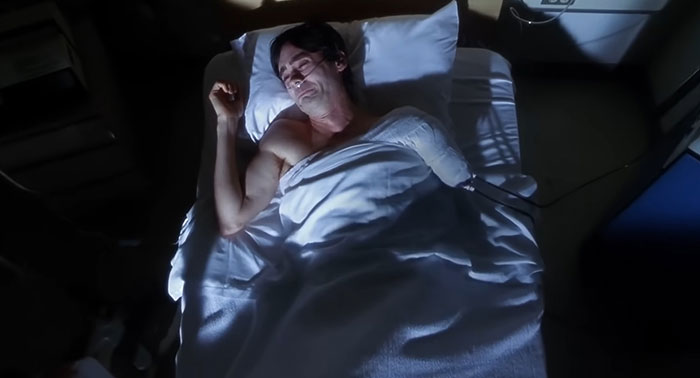 Person lying in hospital bed with a bandaged arm, depicting a sad movie ending.