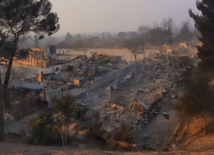 La fire aftermath showing extensive damage and debris, highlighted in the context of Justine Bateman's commentary.