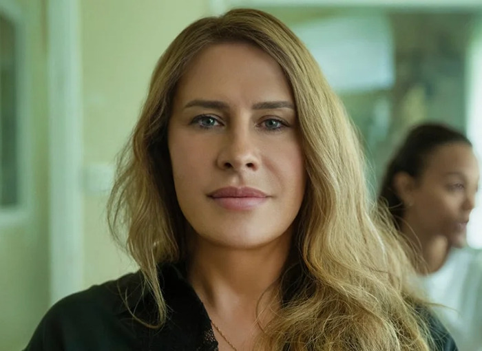 A person with long blonde hair indoors, associated with "Emilia Pérez" director topic.