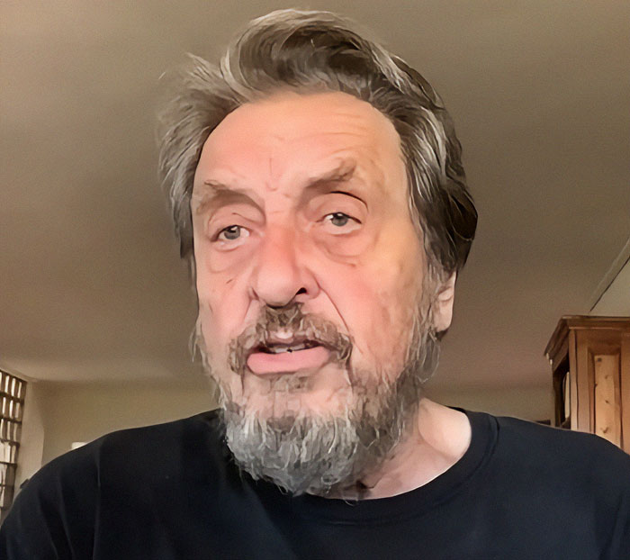 Older man with a beard in a casual home setting, related to Elon Musk's dad and wealth influence.