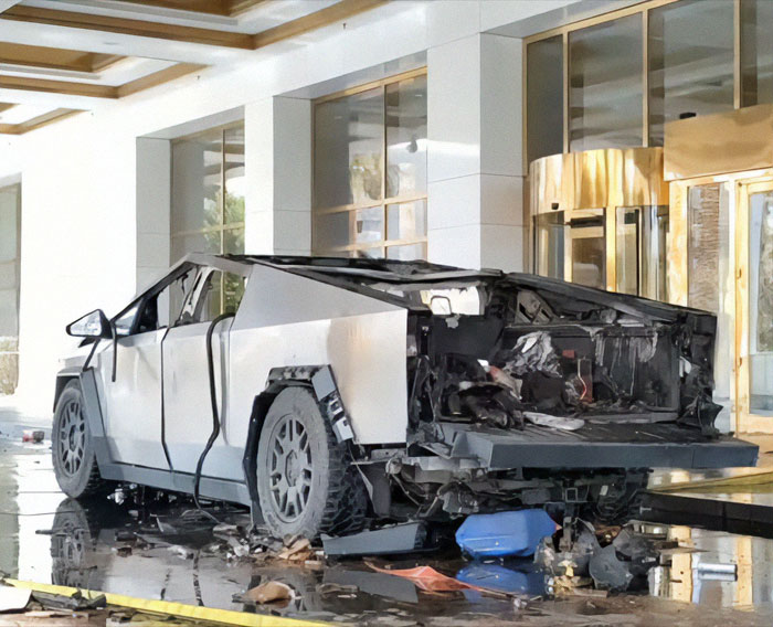 Damaged Cybertruck in a modern building entrance, showing aftermath of an incident.