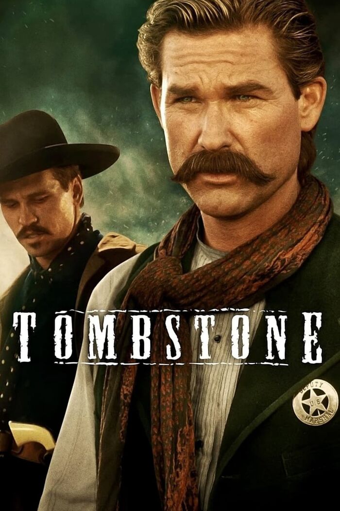 Two men in Western attire, one with a cowboy hat and the other with a mustache. Text reads "Tombstone." Nostalgia movie.