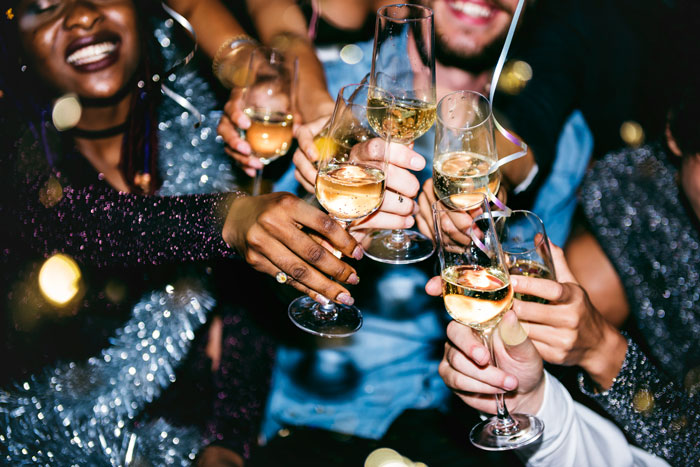 Family toasting with champagne, celebrating New Year's Eve amidst festive decorations.