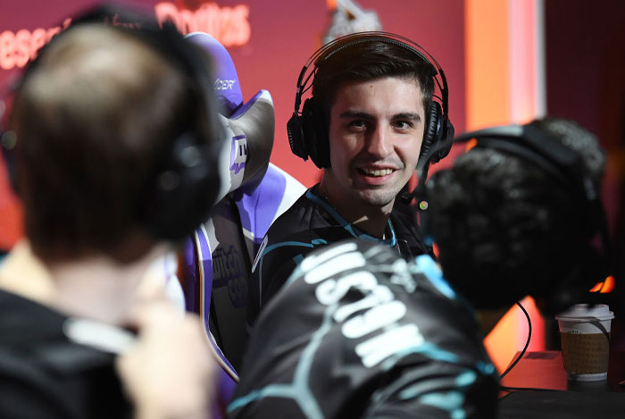 Twitch streamer Shroud (Michael Grzesiek)
wearing headphones engages with others during a gaming event.