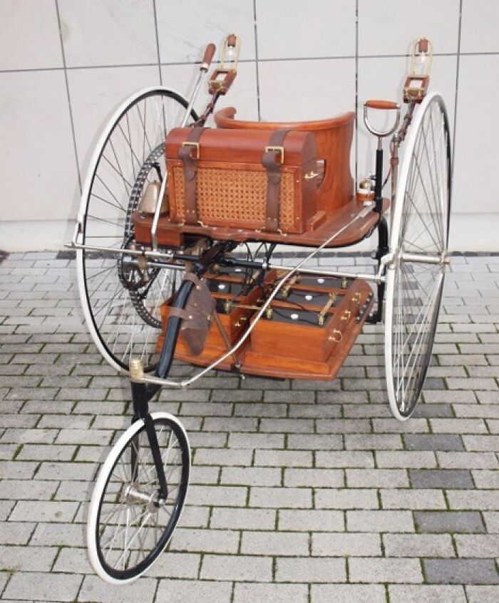 Antique tricycle with wooden components, an example of historical inventions ahead of their time.