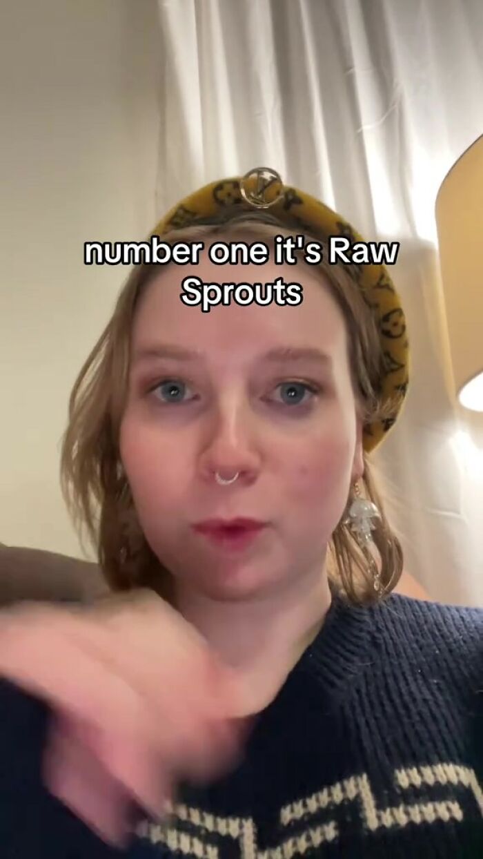 Person discussing raw sprouts and food bacteria risks indoors.