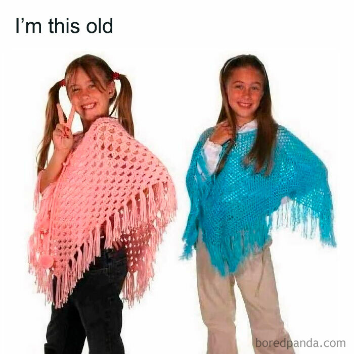 Two girls in vintage ponchos, showcasing a Gen X fashion trend with playful smiles.