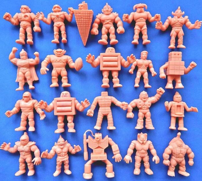 Collection of vintage Gen X collectible figures arranged on a blue background.