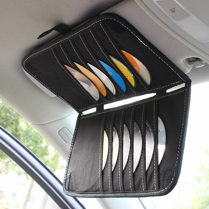 Car visor CD holder filled, illustrating Gen X nostalgia.