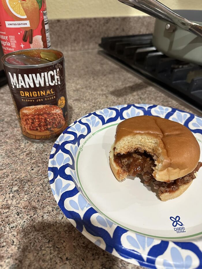 Sloppy Joe in a bun on a paper plate next to a can of Manwich, depicting a classic Gen X meal.