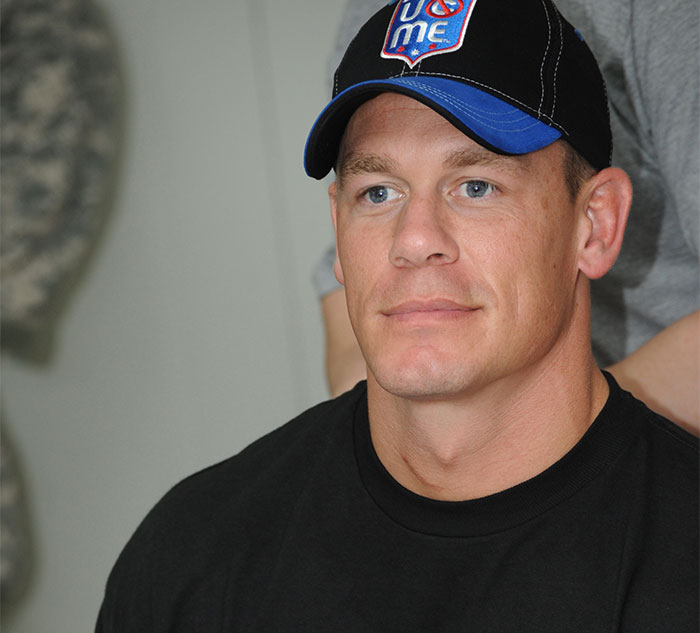 Man wearing a black t-shirt and cap, representing nice celebrity demeanor.