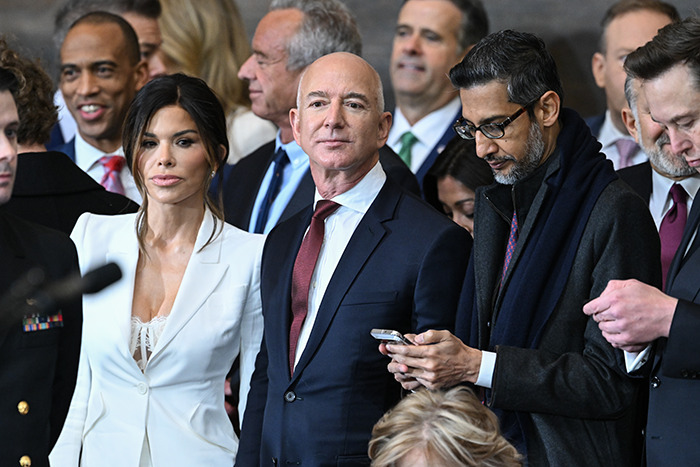 Lauren Sanchez in white attire alongside Jeff Bezos at an event.