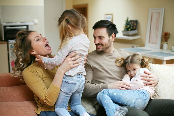 Happy family at home, showcasing kids adapting in a different country setting.