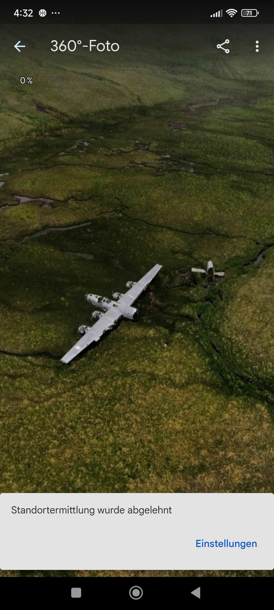 Aerial view of an abandoned airplane on a grassy field, discovered on Google Earth.