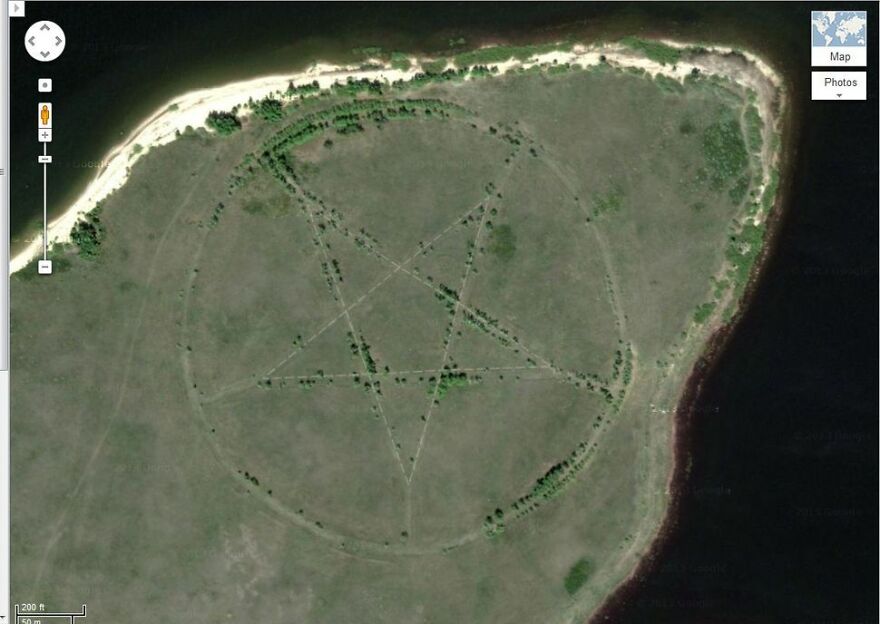 Pentagram shape on a field near water, discovered on Google Earth, intriguing viewers with its mysterious design.