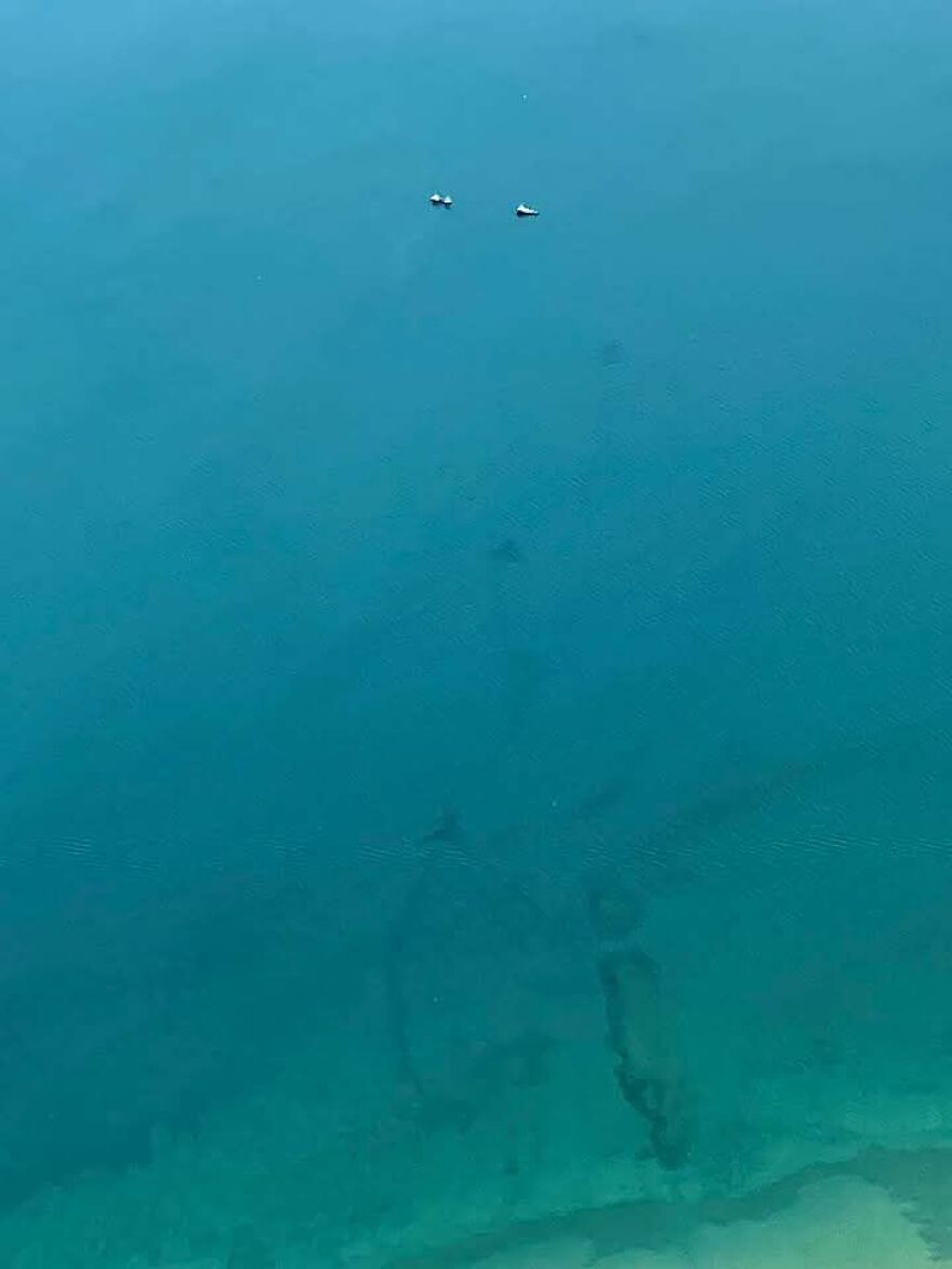 Strange underwater structure visible on Google Earth, surrounded by blue ocean, with two small boats nearby.