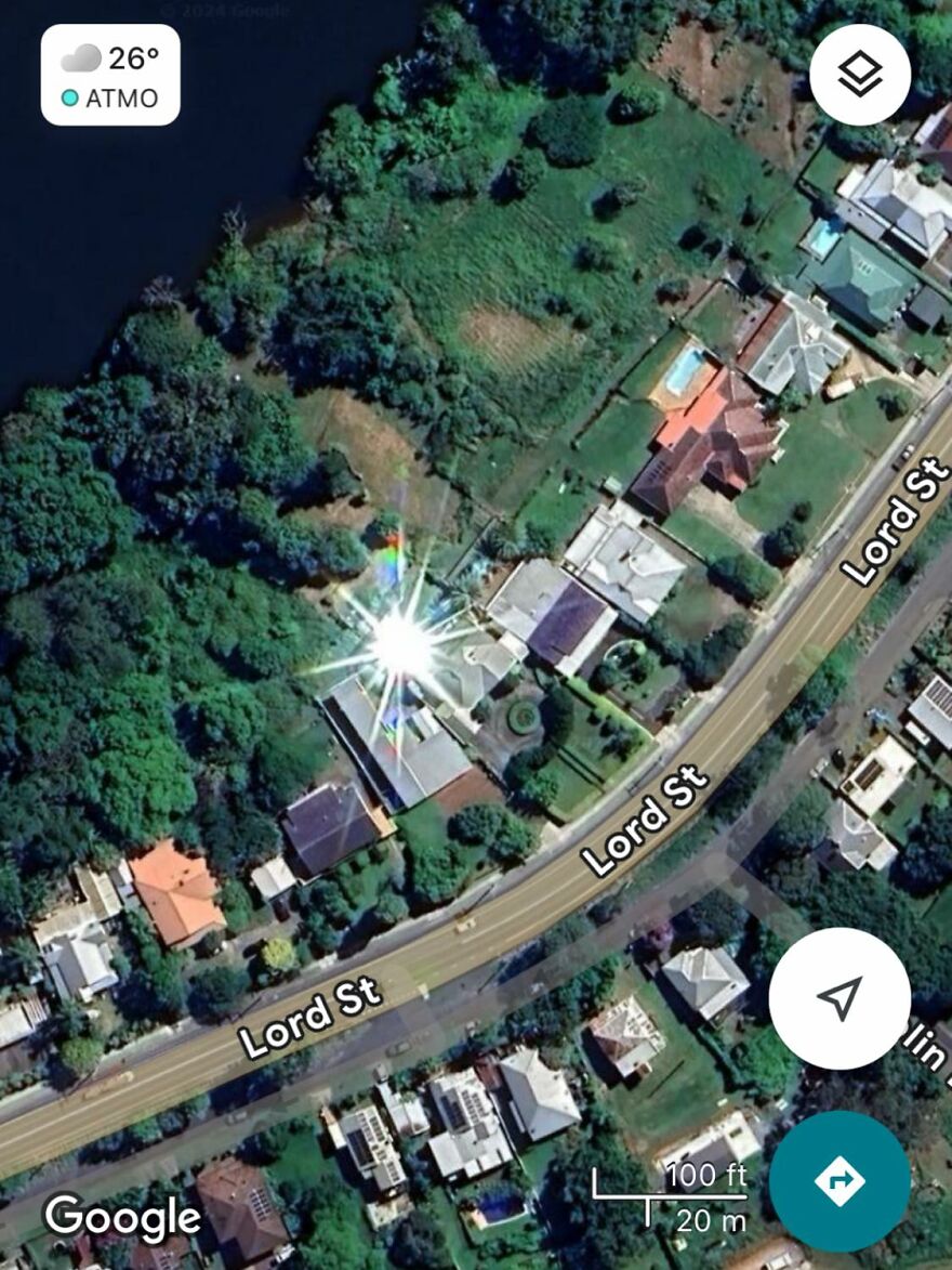 Strange reflection seen in Google Earth view of houses along Lord St, surrounded by greenery.