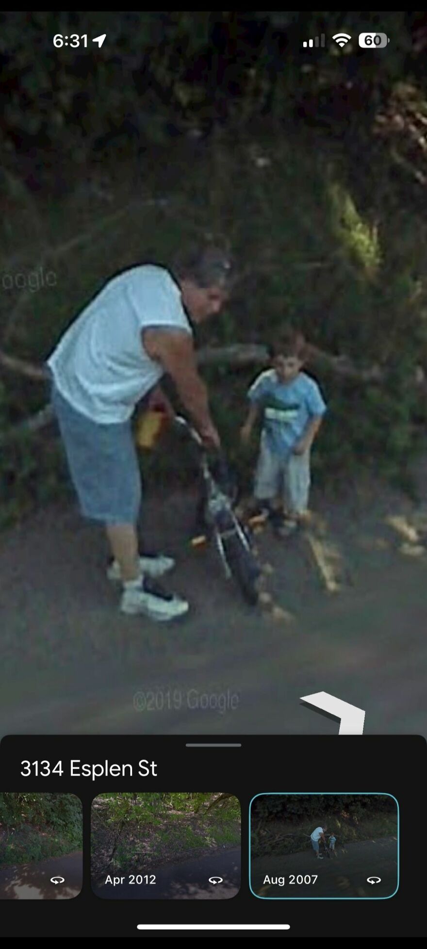 "Strange find on Google Earth: man helping child with bike on a shady street, captured in Aug 2007 at 3134 Esplen St."