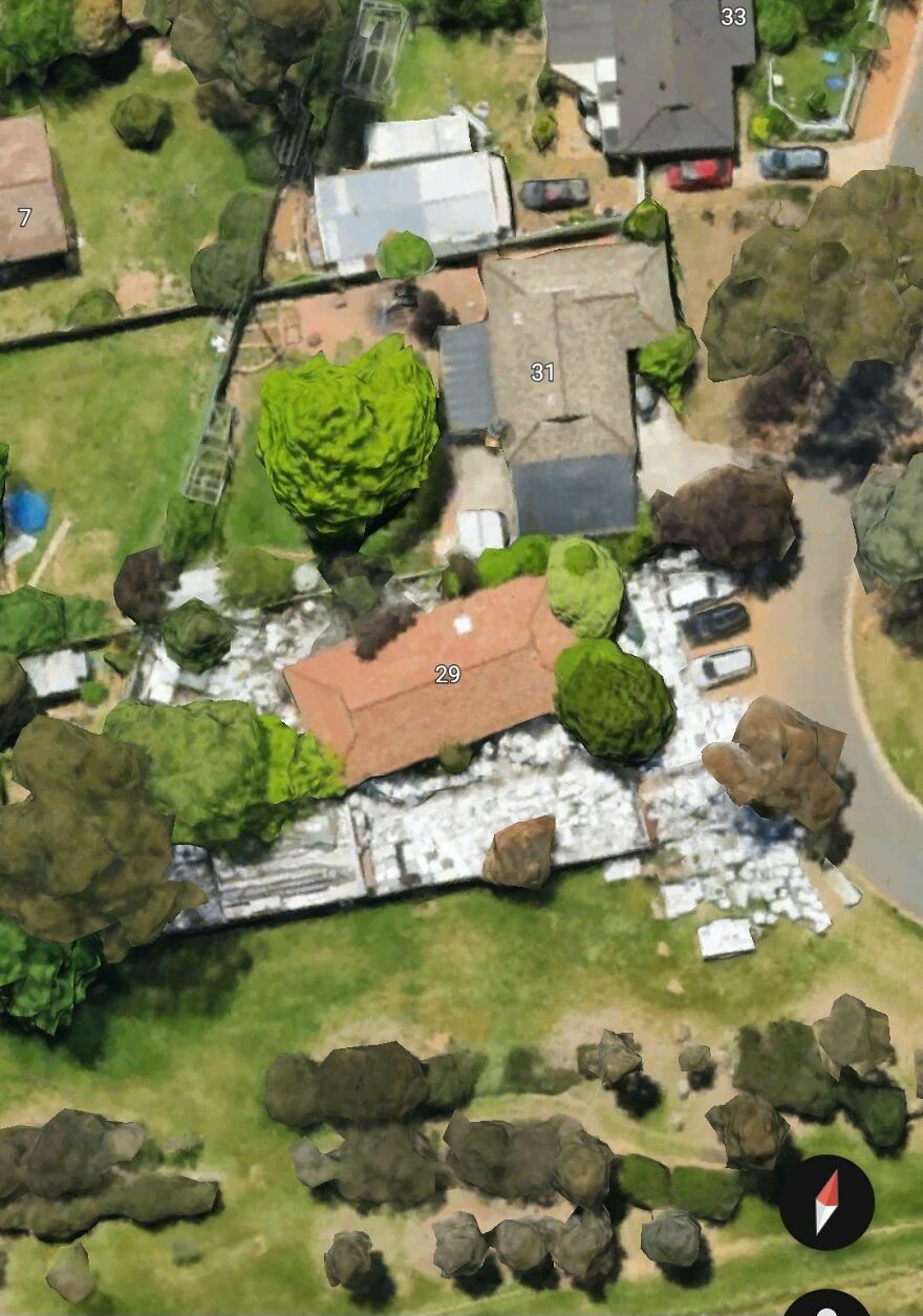 A strange aerial view of a suburban area found on Google Earth, showing diverse buildings and greenery.