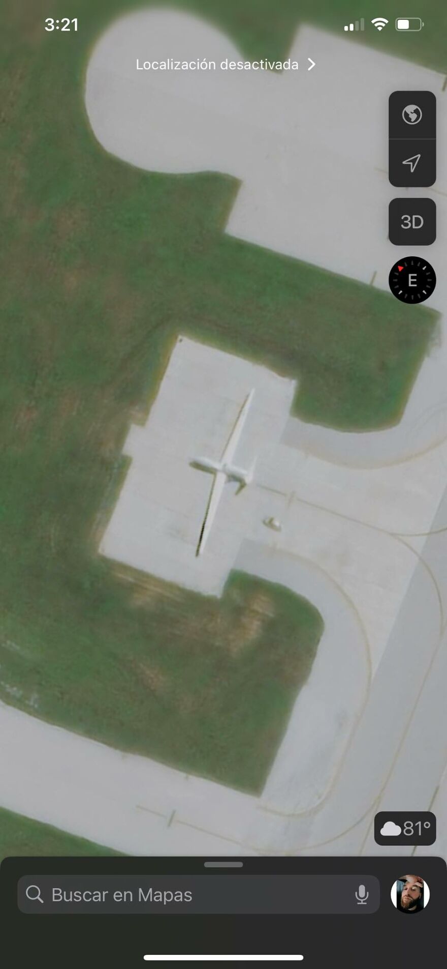 Strange things on Google Earth: satellite view of an airplane-shaped building on a grassy area.