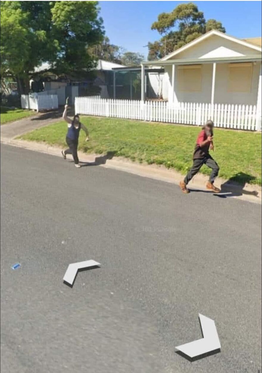 Two people running on a suburban street, captured on Google Earth.