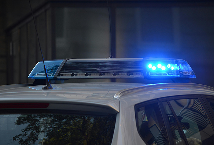 Police car with blue lights flashing, representing a woman's disappearance and Google Maps aiding in closure.