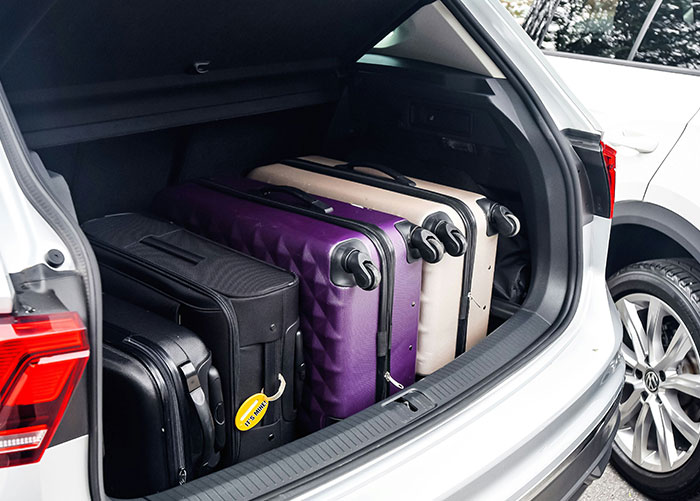 Car trunk filled with luxury suitcases, representing the lifestyle of wealthy people accustomed to extraordinary norms.