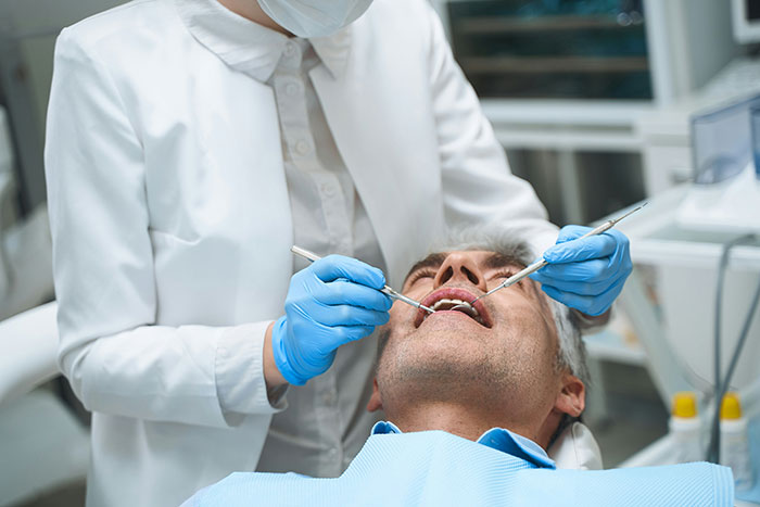 Patient at the dentist's office receiving a dental checkup, a life lesson in maintaining oral health.
