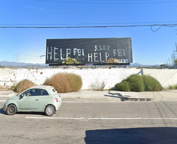 Billboard with "HELP" signs in graffiti, taken from Google Earth, sparking conspiracy theories.