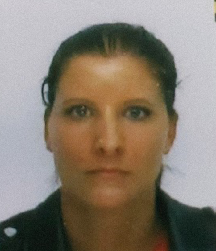 A woman's passport-style photo related to sisters' disappearance after a night walk, with serious expression.