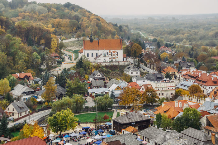 Charming village in Tuscany, Italy with historic buildings nestled in a lush, hilly landscape during autumn.