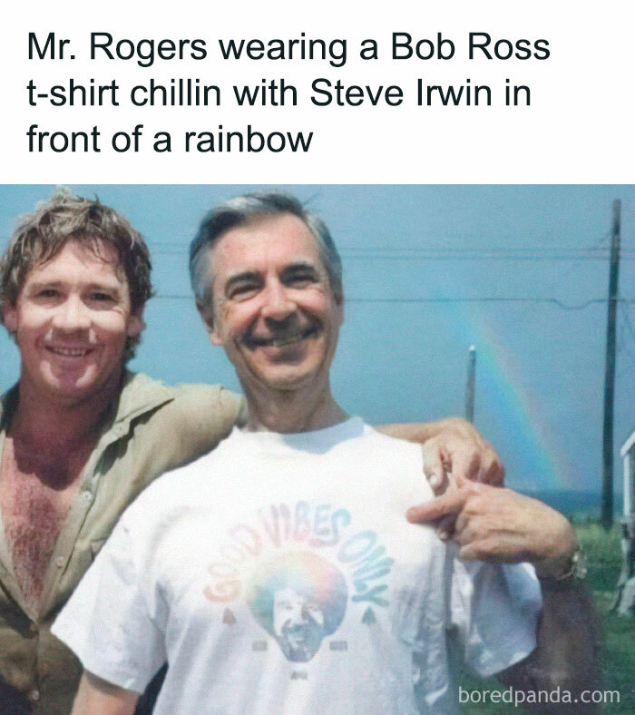 Two men smiling with a rainbow in the background, one wearing a "Good Vibes Only" Bob Ross t-shirt.