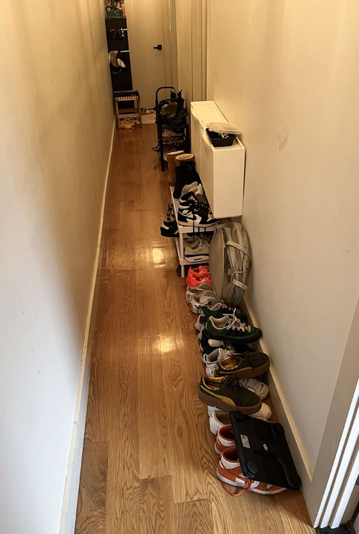 Cluttered hallway with shoes scattered, illustrating horrible roommates' messy habits.