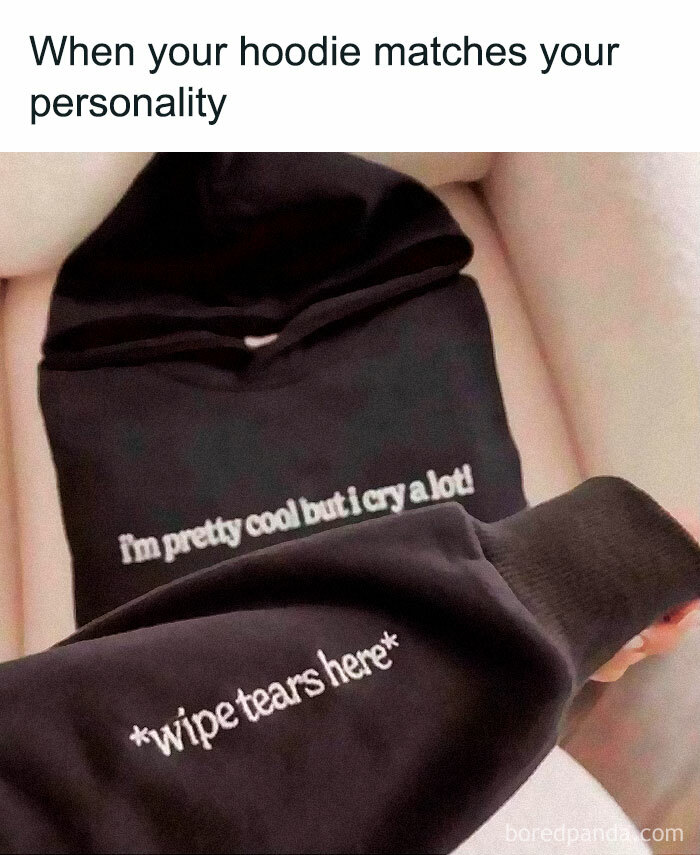 Hoodie with funny meme text, "I'm pretty cool but I cry a lot" and "wipe tears here," humorously matching personality.