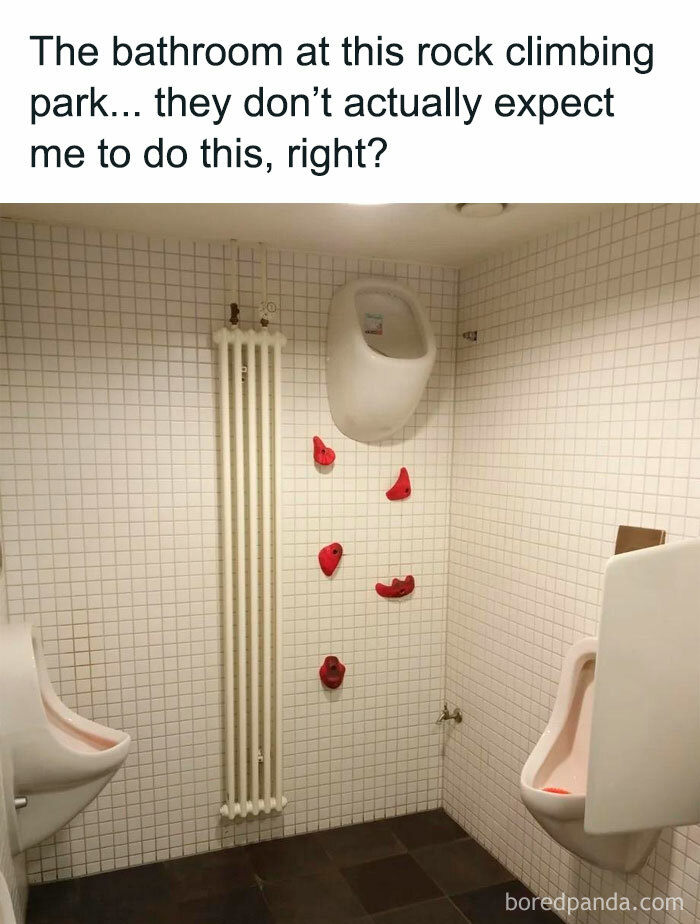 Bathroom with humorous rock climbing holds on wall, showcasing a random meme.