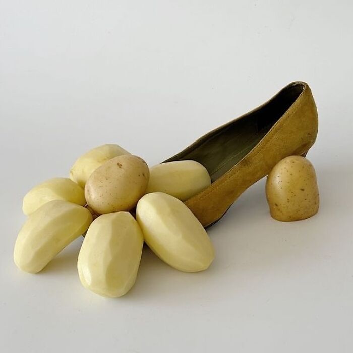 Sculptural footwear crafted from a high heel adorned with peeled and unpeeled potatoes.