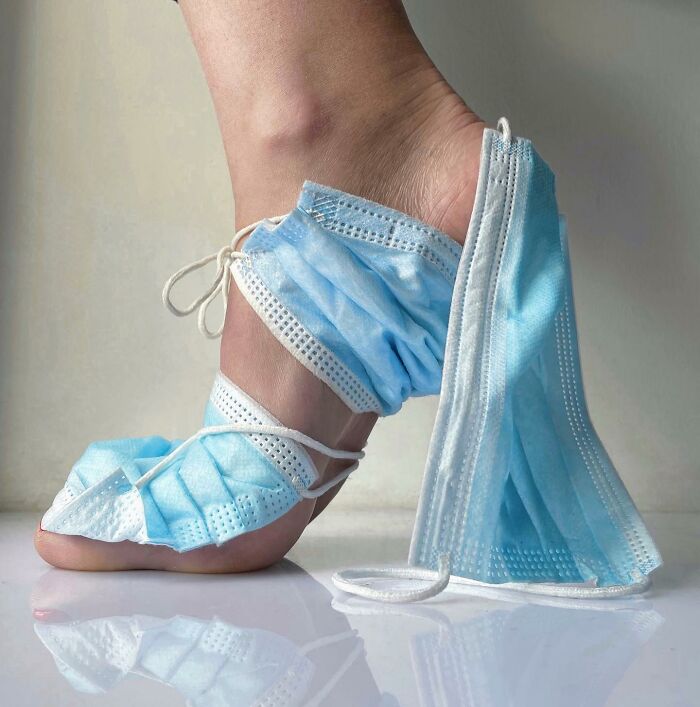 Sculptural footwear made from blue face masks, creatively wrapped around a foot.