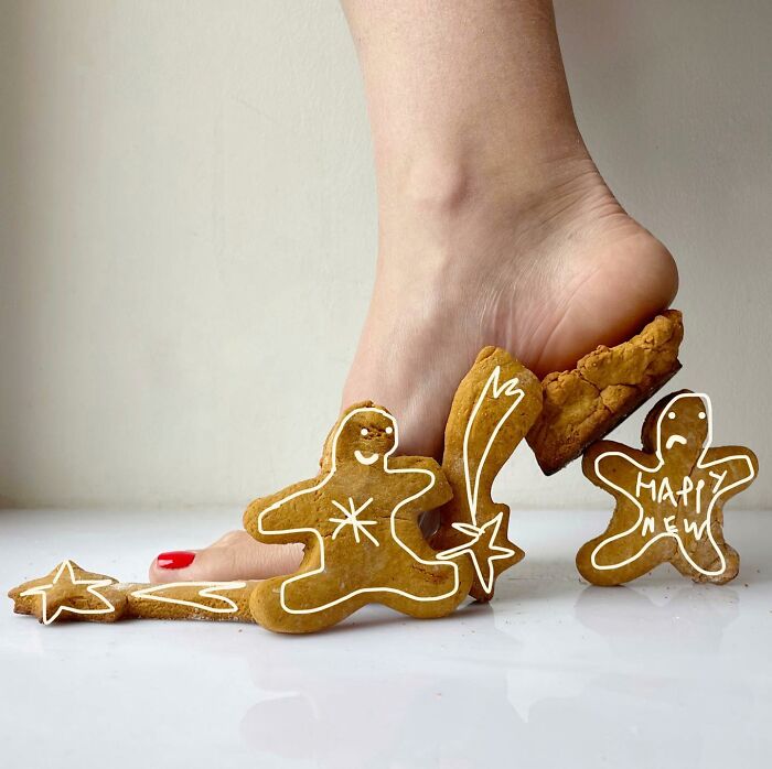 Sculptural footwear made from gingerbread cookies, featuring a foot stepping on the creative design.