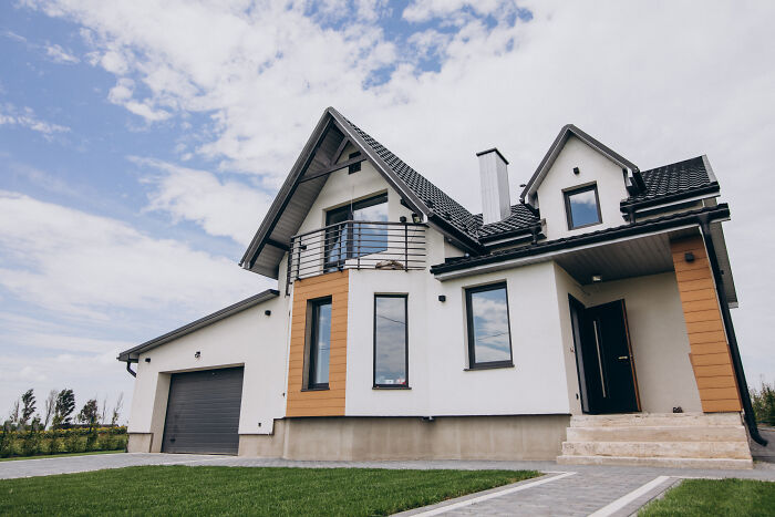 Modern house with a well-kept lawn, symbolizing family and care responsibilities.