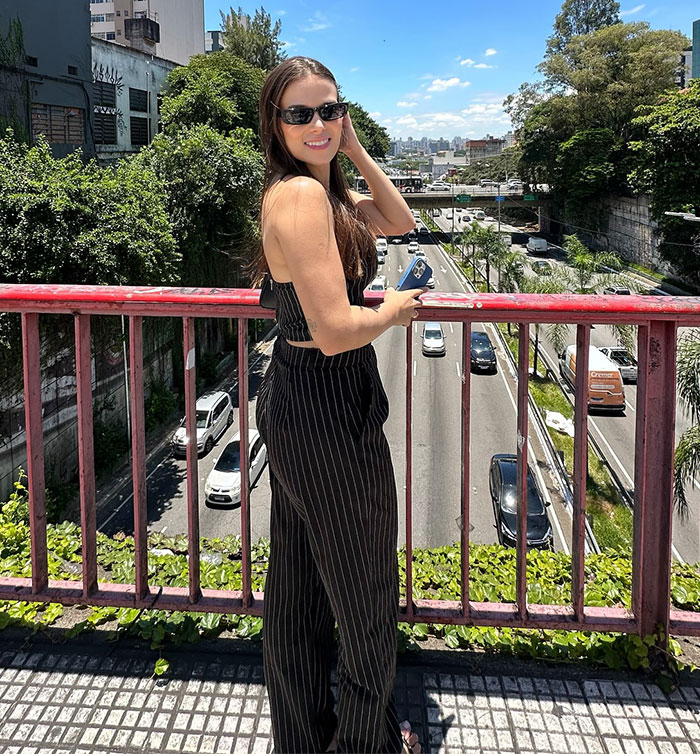 Person on a bridge in sunglasses, related to a seat swap lawsuit involving a crying kid.