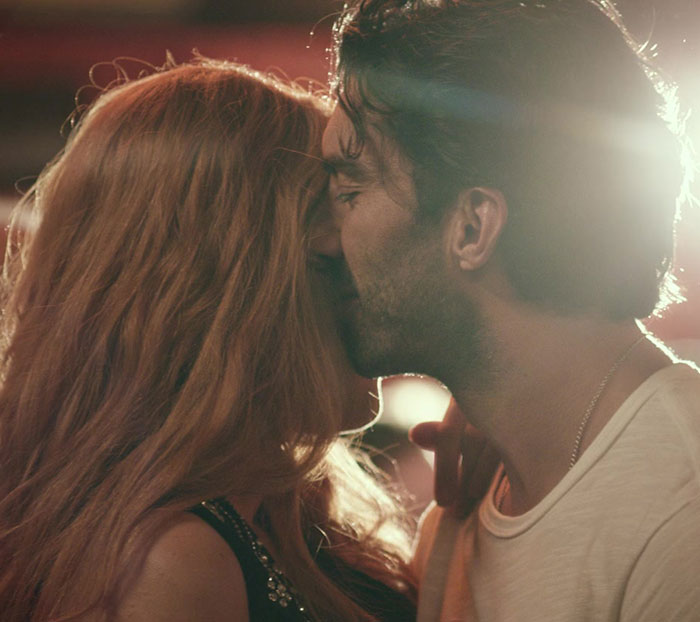 Two actors in an intimate scene, with warm lighting highlighting their profiles.