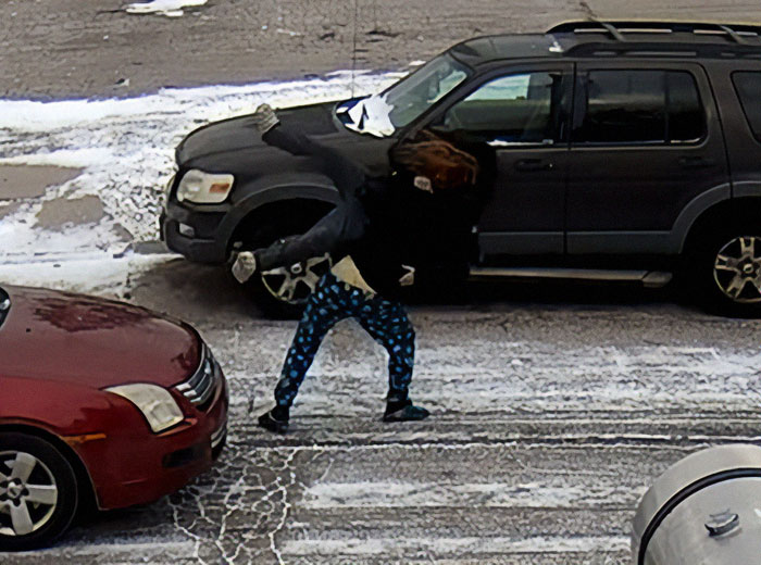 Road rage incident with a person being lifted and thrown on a snowy street near parked cars.