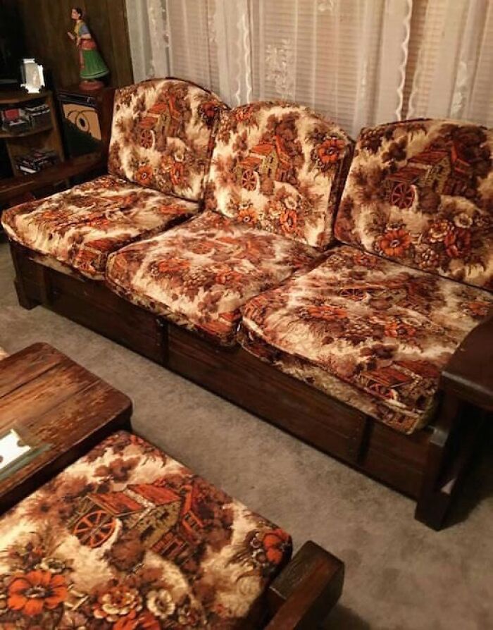 80s nostalgia couch with floral and rustic village pattern in a vintage living room setting.