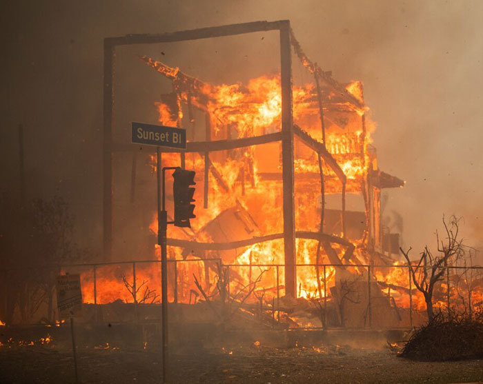 Wildfire consuming structure on Sunset Blvd in LA, highlighting tragedy causes.