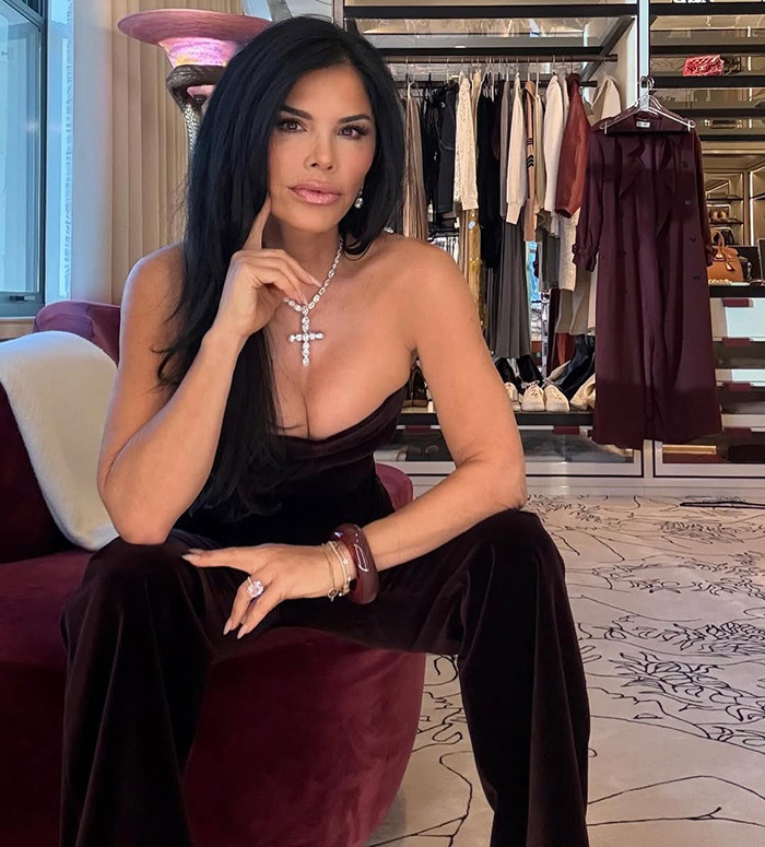 Lauren Sanchez in an elegant outfit sitting in a fashionably designed closet area.