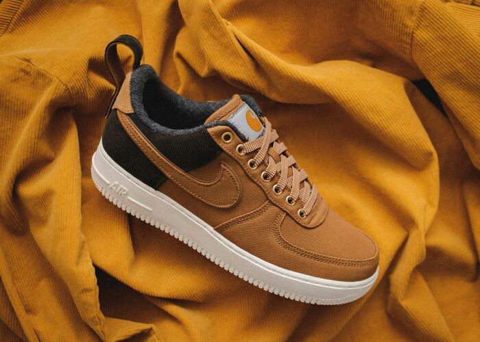 Brown sneaker on a mustard-colored fabric background.